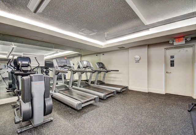 gym featuring a textured ceiling