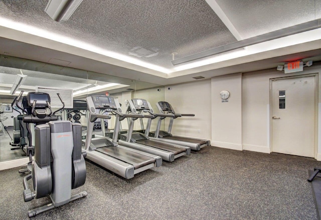 610 Clematis St Unit 638, West Palm Beach, FL 33401 - workout area featuring a textured ceiling and baseboards