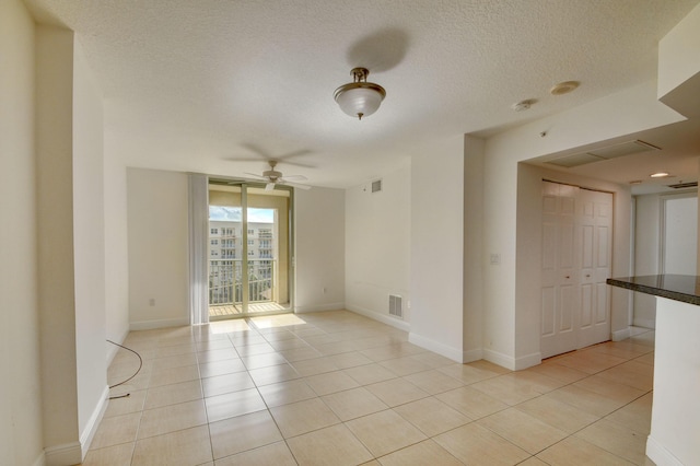 610 Clematis St Unit 638, West Palm Beach, FL 33401 - empty room featuring light tile patterned floors, ceiling fan, a smoke detector, and a textured ceiling