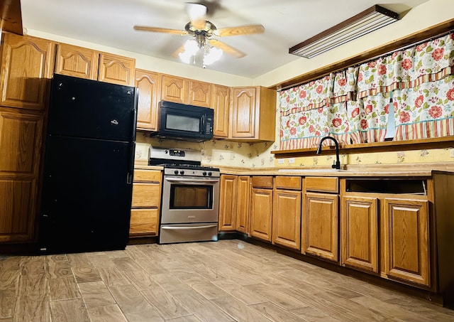 kitchen with ceiling fan, light hardwood / wood-style floors, sink, and black appliances