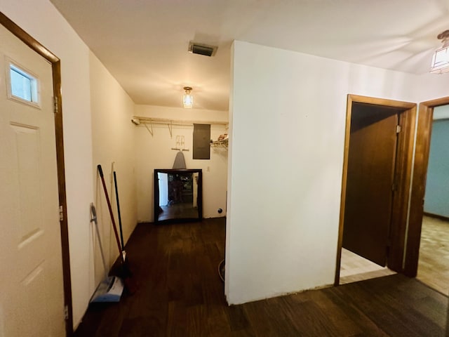 hall with dark hardwood / wood-style floors and electric panel