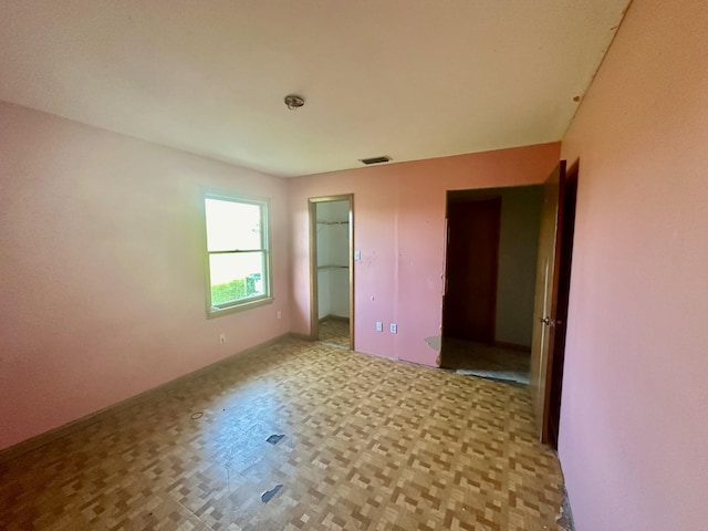 unfurnished bedroom featuring light parquet flooring