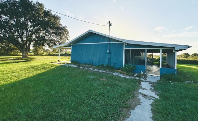 rear view of property featuring a lawn