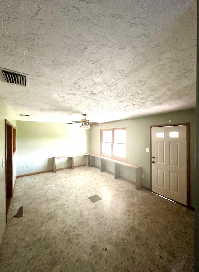 unfurnished living room with carpet flooring and ceiling fan