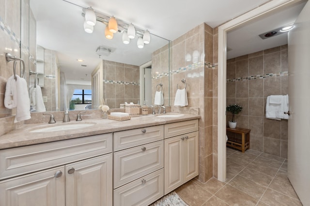 bathroom featuring tile patterned floors, vanity, and tile walls