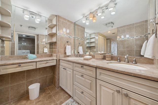 bathroom with vanity, a shower with door, tile patterned flooring, decorative backsplash, and tile walls