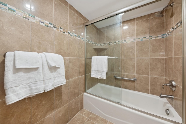 bathroom with tile patterned floors and shower / bath combination with glass door