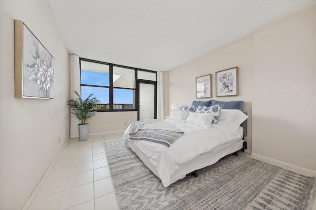 tiled bedroom featuring a textured ceiling