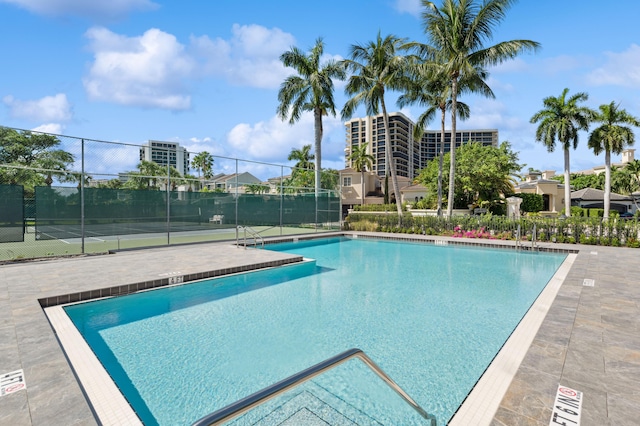 view of pool featuring tennis court