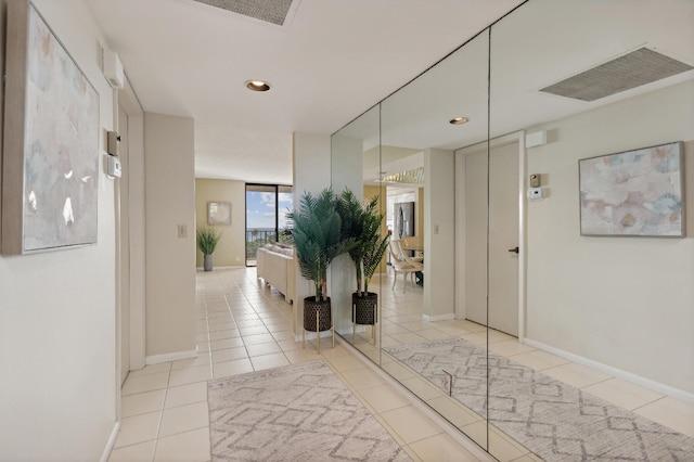 hall featuring light tile patterned floors