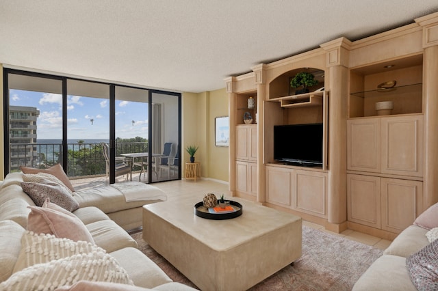 tiled living room with a textured ceiling and a wall of windows