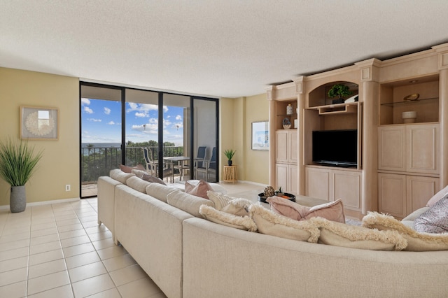 tiled living room featuring a wall of windows and a textured ceiling