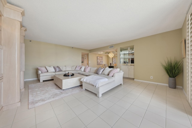 living room featuring light tile patterned floors and a textured ceiling