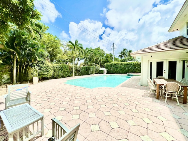 view of pool featuring french doors and a patio