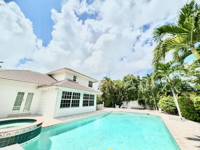 view of pool featuring an in ground hot tub and french doors