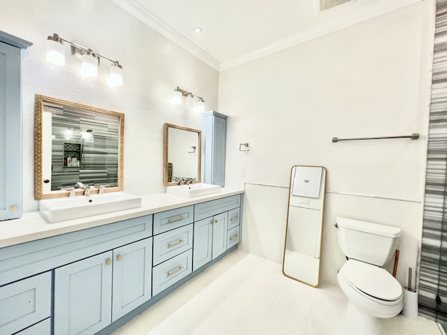 bathroom featuring crown molding, vanity, and toilet