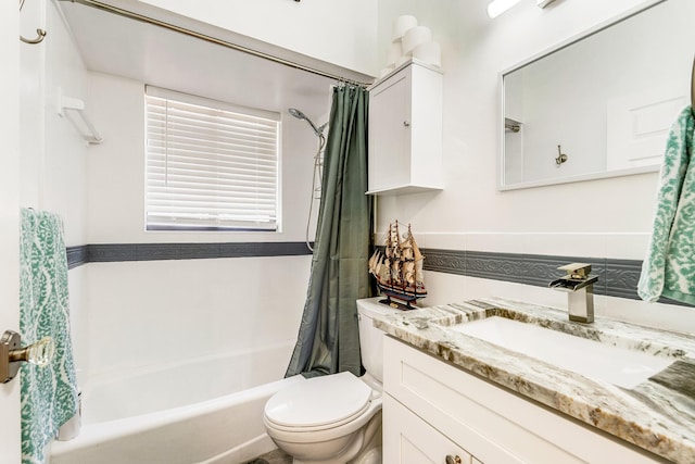 full bathroom with toilet, tile walls, vanity, and shower / bath combo with shower curtain