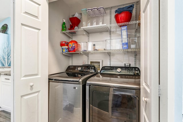 clothes washing area with separate washer and dryer