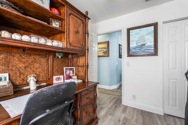 office with light hardwood / wood-style flooring