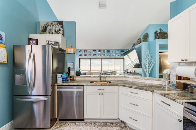 kitchen with white cabinets, stone countertops, sink, and appliances with stainless steel finishes