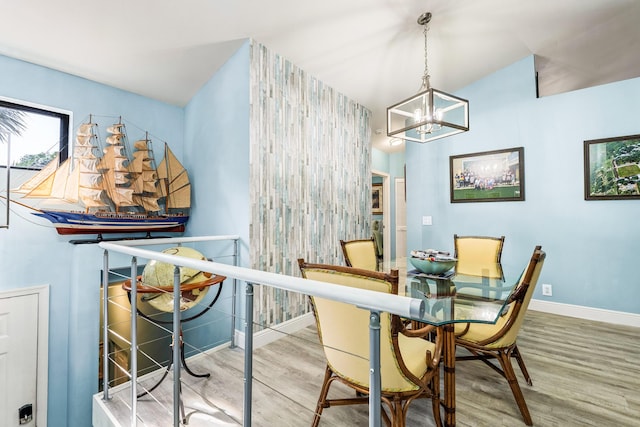 dining room featuring hardwood / wood-style floors and a notable chandelier