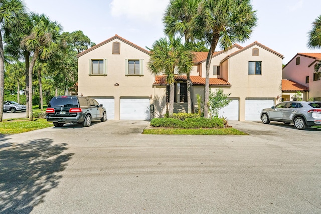 mediterranean / spanish house featuring a garage