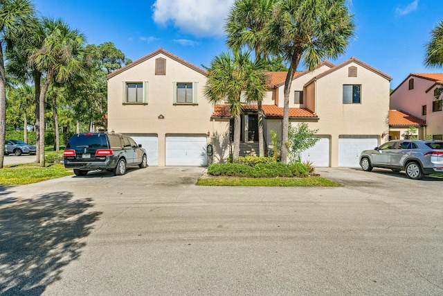 mediterranean / spanish-style home with a garage