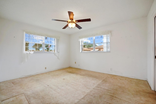 unfurnished room featuring ceiling fan and light carpet