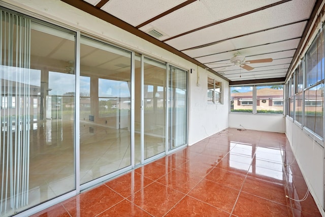 unfurnished sunroom featuring a paneled ceiling and ceiling fan