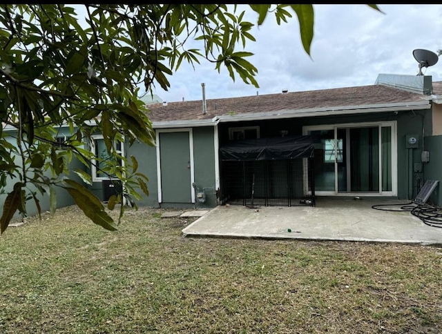 rear view of house with a patio area and a yard