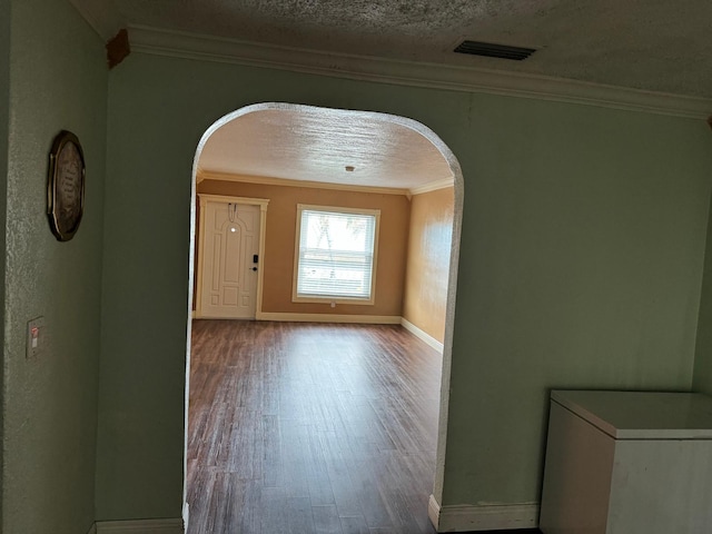 interior space with crown molding, hardwood / wood-style floors, and a textured ceiling