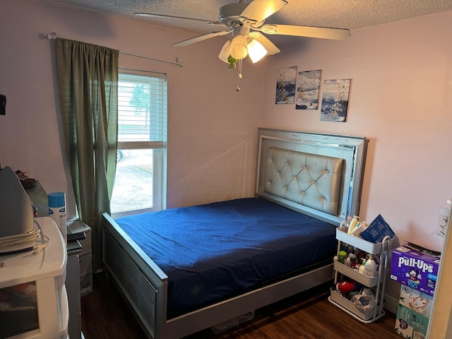 bedroom featuring a textured ceiling, dark hardwood / wood-style flooring, and ceiling fan