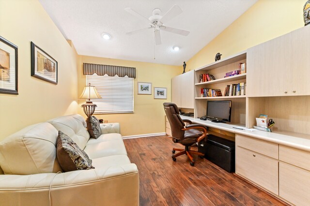 office space featuring ceiling fan, dark wood-type flooring, and lofted ceiling