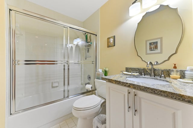 full bathroom with tile patterned floors, vanity, enclosed tub / shower combo, and toilet