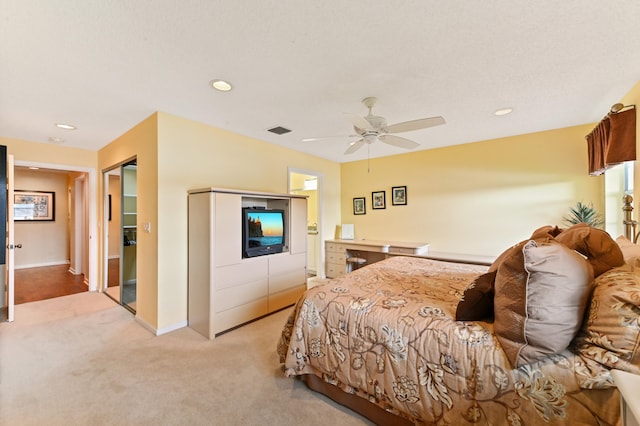 bedroom with ceiling fan and light colored carpet