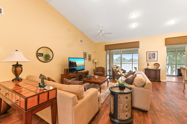 living room featuring dark hardwood / wood-style flooring, high vaulted ceiling, and ceiling fan