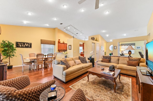 living room featuring ceiling fan, light wood-type flooring, and lofted ceiling