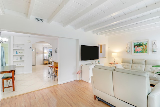 living room with beamed ceiling, light hardwood / wood-style floors, wooden ceiling, and built in features