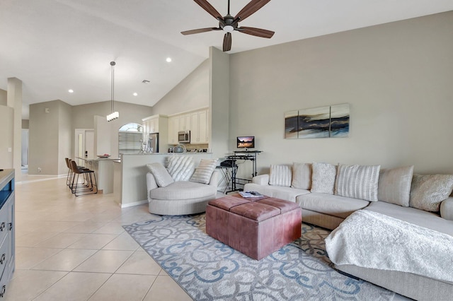 living room with ceiling fan, light tile patterned floors, and high vaulted ceiling