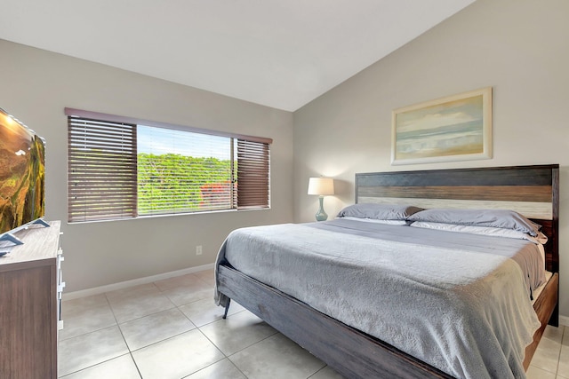 bedroom featuring light tile patterned flooring and lofted ceiling