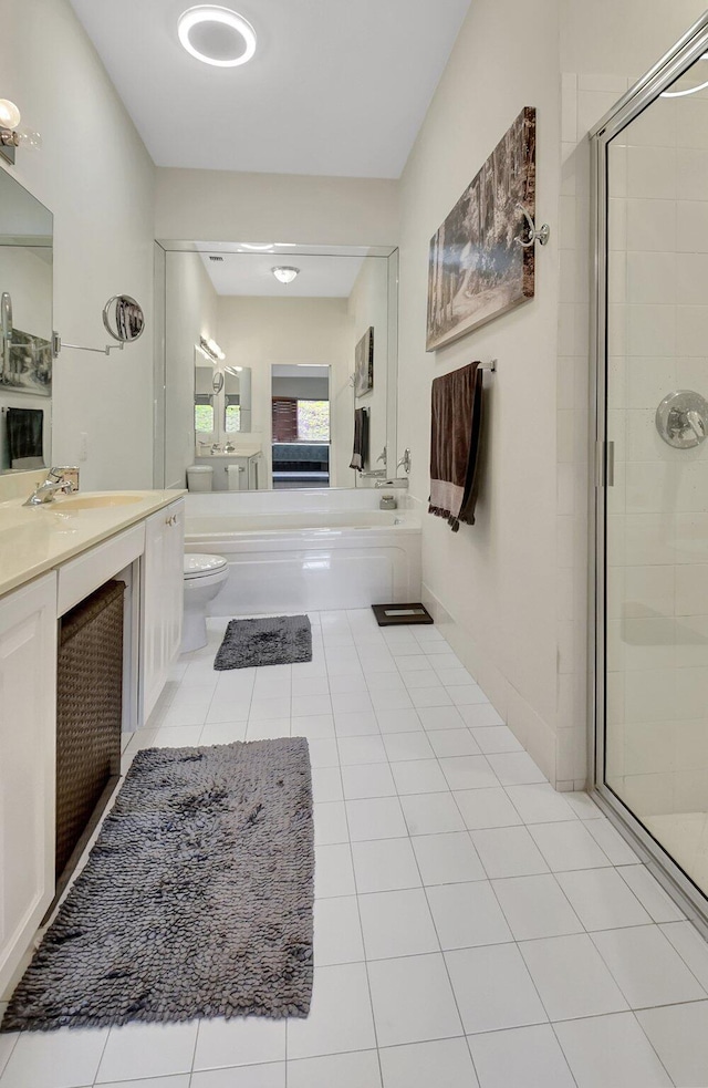 full bathroom featuring shower with separate bathtub, vanity, and toilet