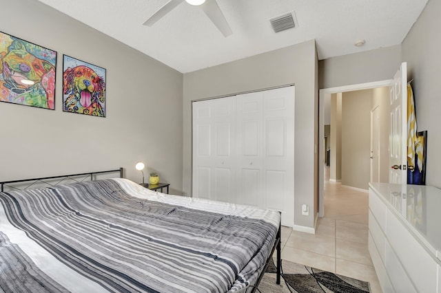 tiled bedroom featuring a closet and ceiling fan