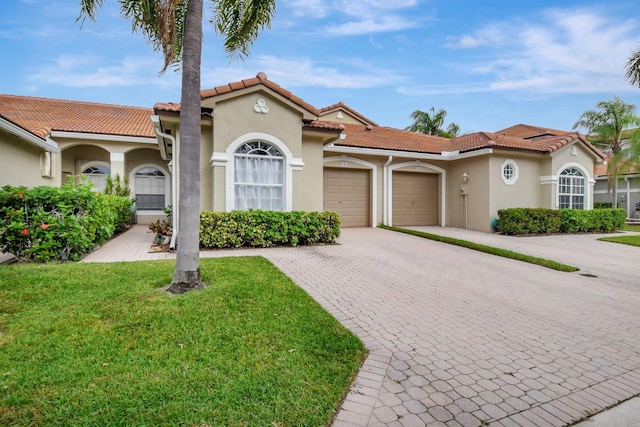 mediterranean / spanish-style house with a front yard and a garage