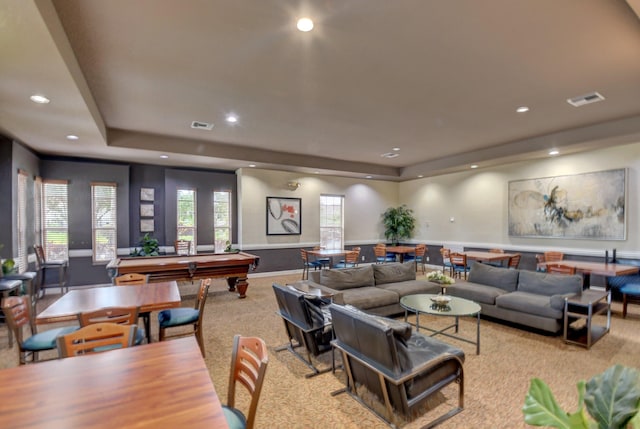 carpeted living room with a tray ceiling and pool table