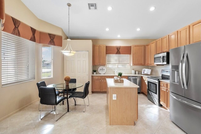 kitchen featuring pendant lighting, light tile patterned floors, appliances with stainless steel finishes, a kitchen island, and decorative backsplash