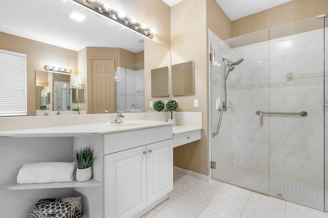 bathroom featuring tile patterned flooring, vanity, and an enclosed shower