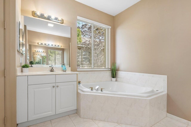 bathroom featuring tile patterned floors, tiled bath, and vanity