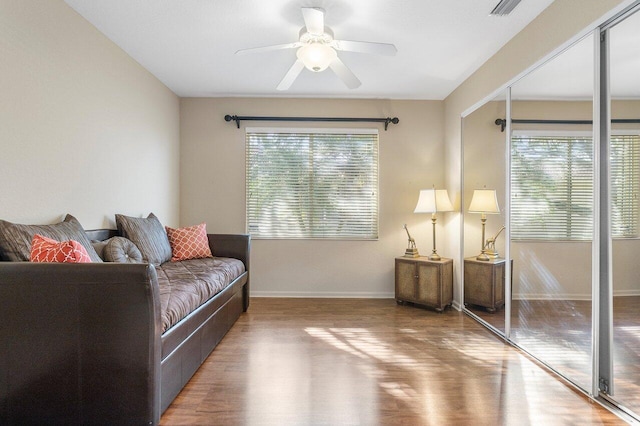 sitting room with hardwood / wood-style flooring and ceiling fan