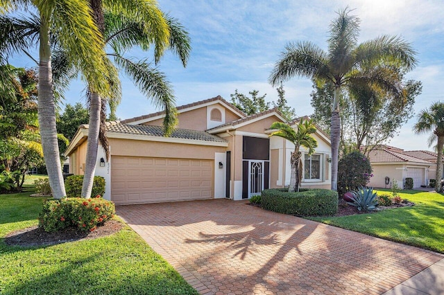 mediterranean / spanish-style home featuring a garage and a front lawn