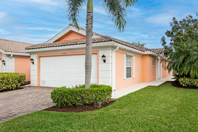 view of home's exterior featuring a lawn and a garage